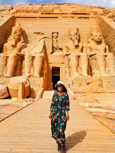 Woman standing in front of Abu Simbel statues.