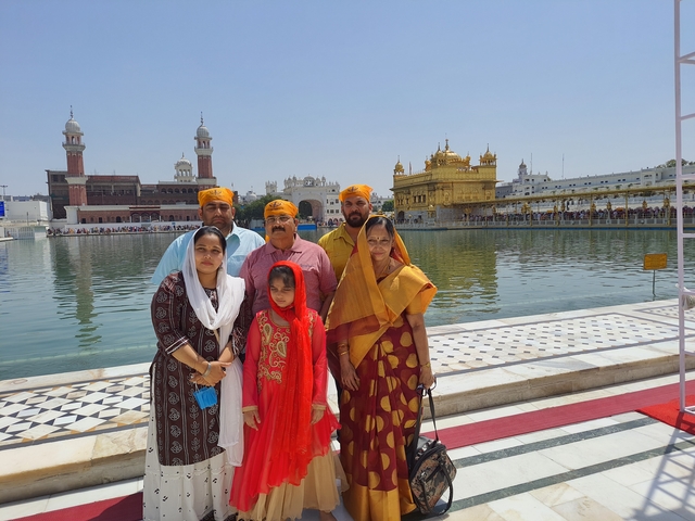 Family portrait in front of a golden temple.