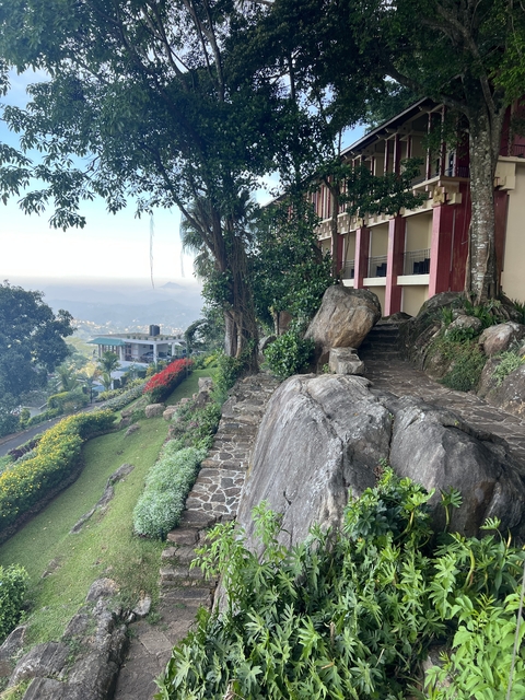 Resort set against a mountainside with landscaped gardens.