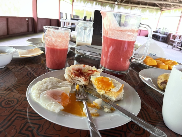 Table served with breakfast including eggs and juice.