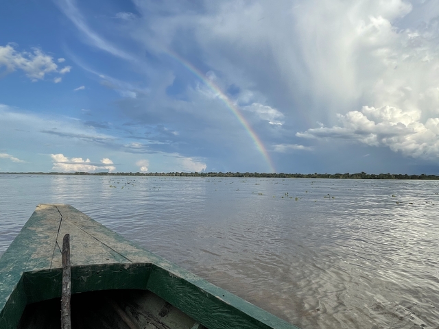 Rainbow over a river landscape.
