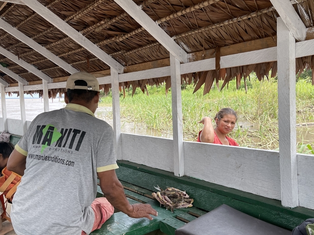 Two people interacting on a riverboat.