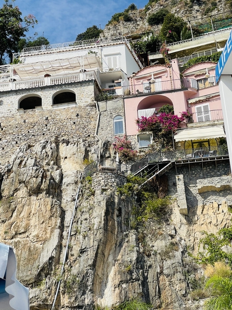 Close-up view of stone architecture and pink bougainvillea.