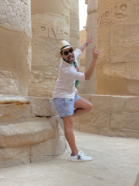 Person posing energetically inside ancient stone structures.