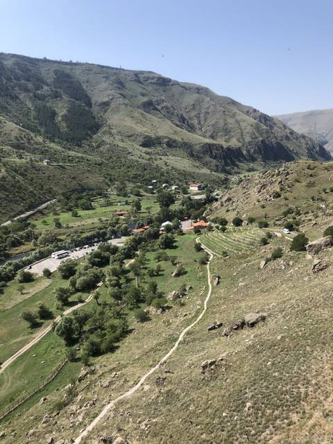 Aerial view of a small village in a mountainous landscape.