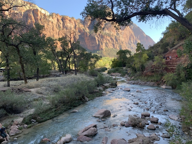 Stream running through a canyon landscape.