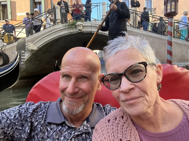 Couple enjoying a gondola ride through Venice.