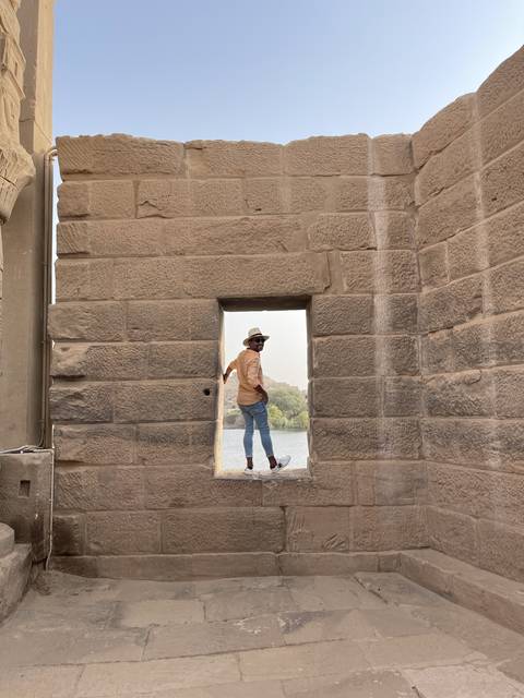 Person standing in an ancient stone window.