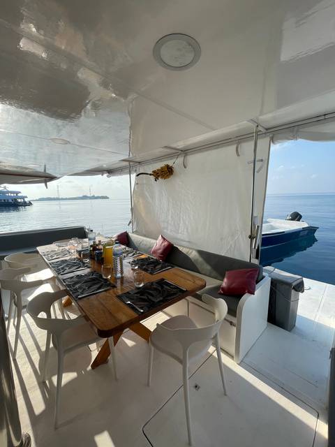 Dining area on a boat set for a meal.