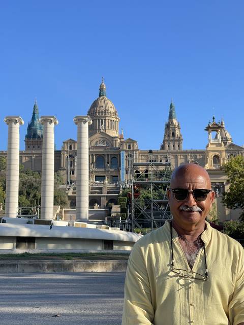 Person in front of a grand building with columns.