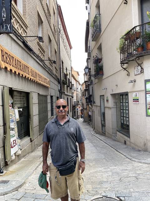 Person walking down a quaint street.