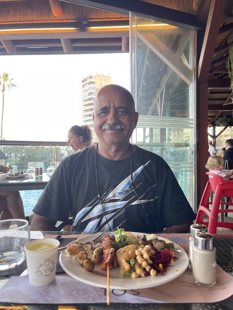 Person dining at a restaurant, enjoying a meal.