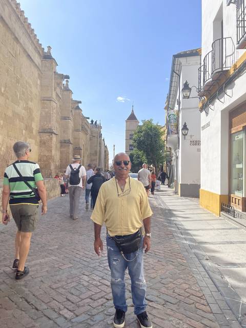 Person walking down a historic stone street.