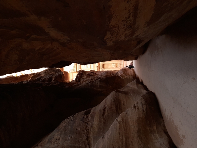 Natural rock formation with an opening showing light.