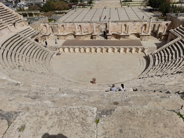 Large ancient amphitheater with stone seating.