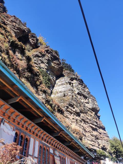 A cliffside view with part of a building structure.
