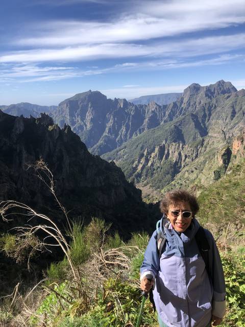 Person hiking with a view of mountains.