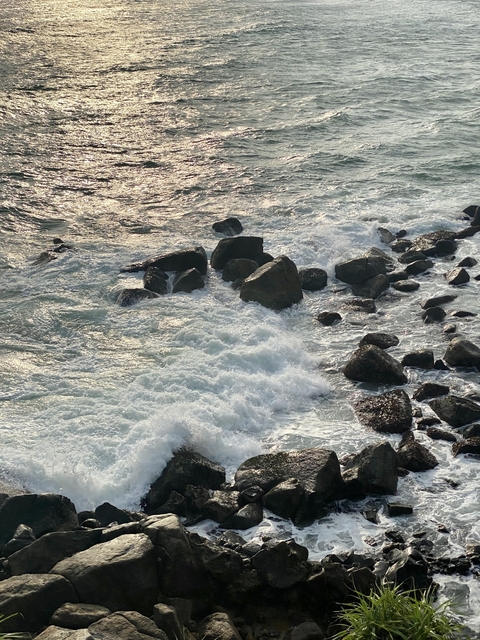 Waves crashing against rocks in the ocean.