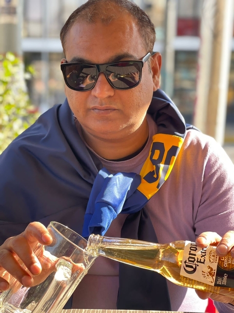 A person with a blue and yellow scarf wrapped around their shoulders.