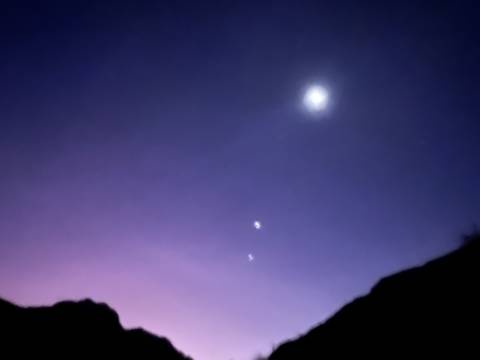 A blurry sky scene with stars or celestial bodies.