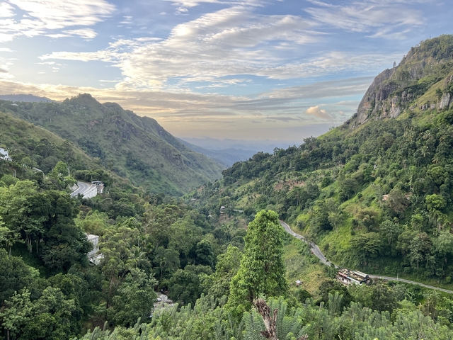 A vast valley with winding roads and mountains.