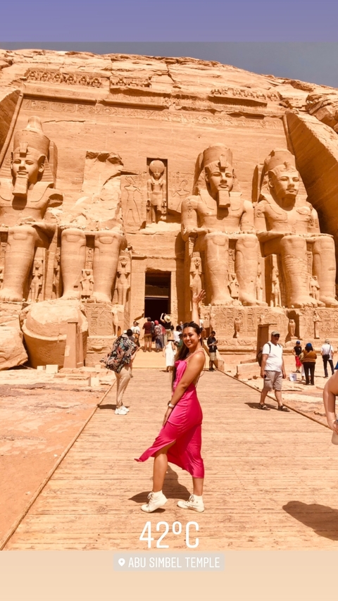 Tourist posing in front of Abu Simbel temples.