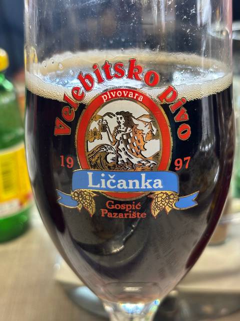 A glass with a logo featuring a dragon.