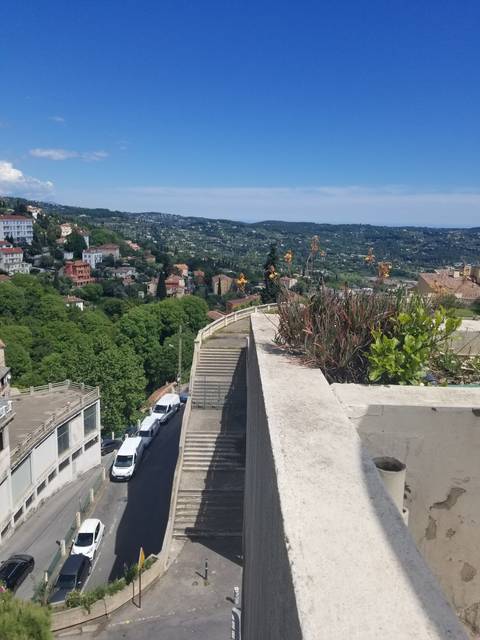 View from a rooftop with a scenic landscape in the distance.