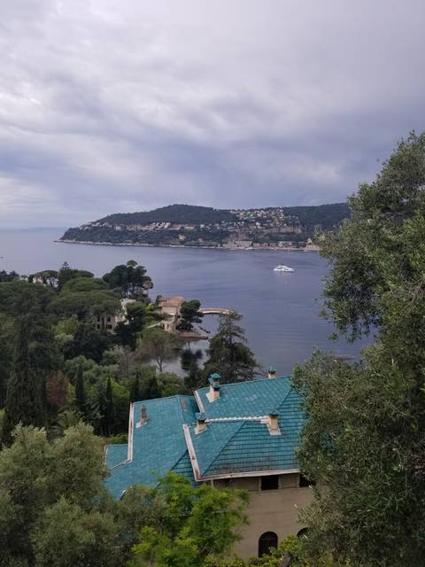 Landscape view of a coastal town with buildings and shoreline.