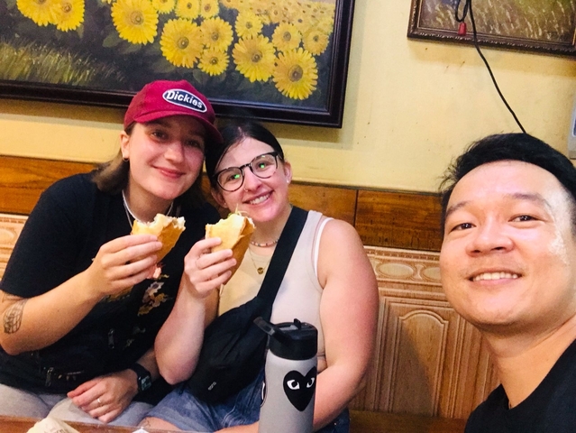 Group enjoying food together inside a restaurant.