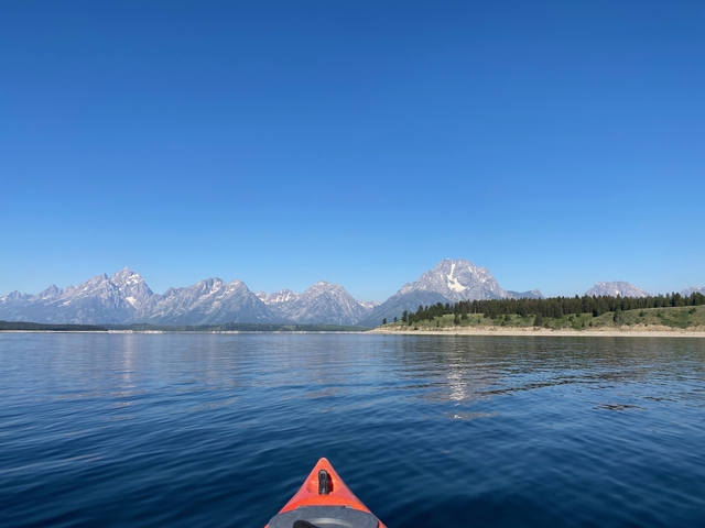Mountains and a lake under a clear blue sky at Grand Teton National Park.