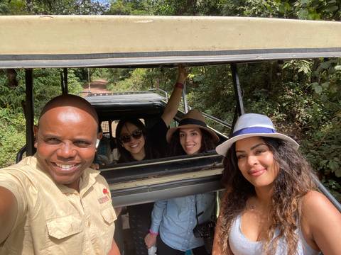 Group of people inside a safari vehicle.