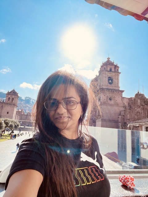 Portrait of a person with historical buildings in the background.