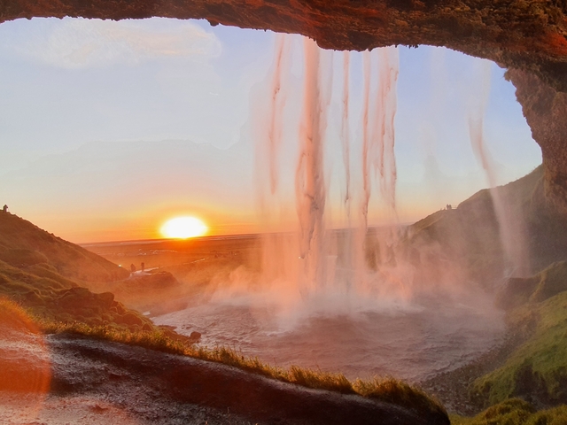 Waterfall view from behind during sunset.
