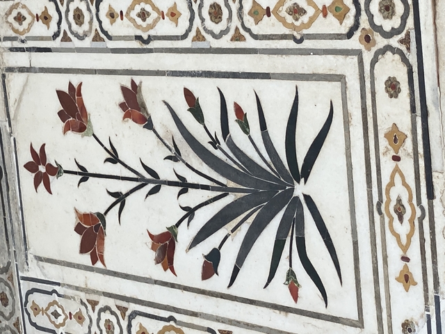 Detailed floral design on a marble surface.