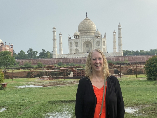 Woman smiling with the Taj Mahal in the background.