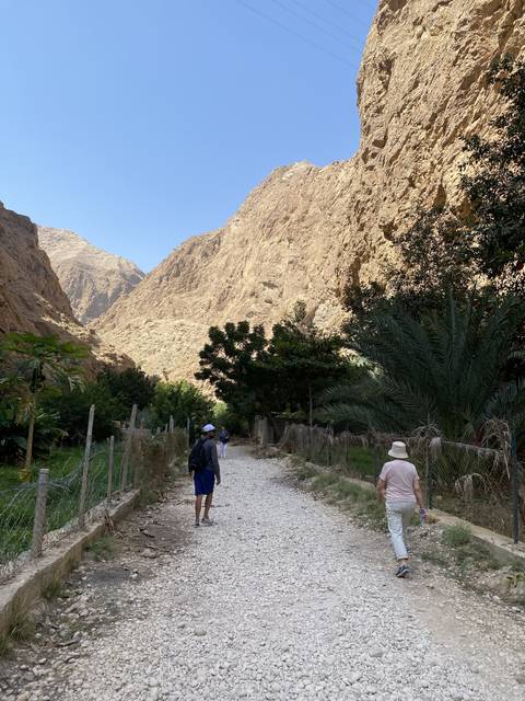 People walking along a mountainous path.