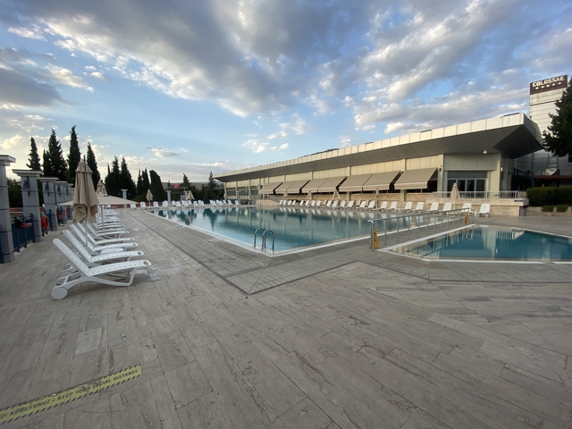 Modern swimming pool area adjacent to a building.