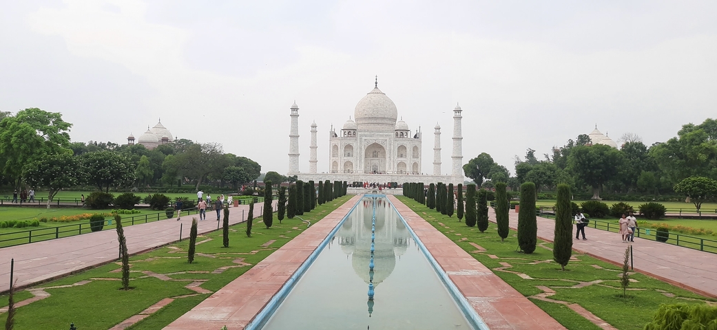 Frontal view of the Taj Mahal with a reflecting pool.
