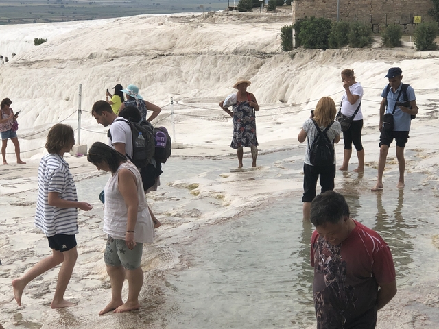 Visitors exploring mineral-rich thermal terraces.