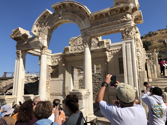 Tourists taking photos of historical ruins.