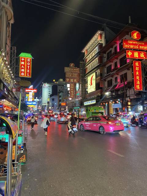 Nighttime city street bustling with activity.