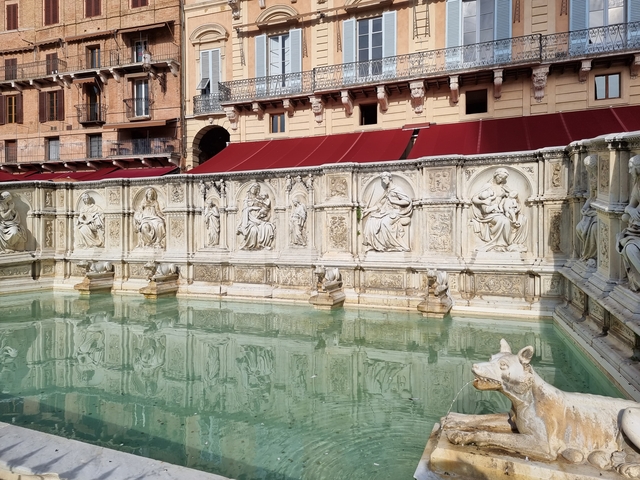 Intricately carved fountain in a public square.
