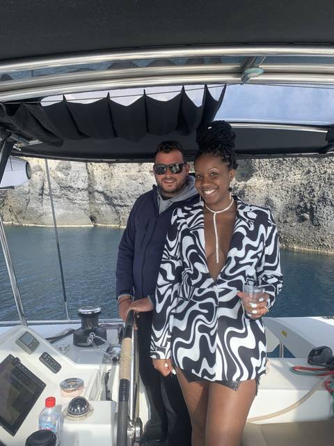 People on a boat with coastal views.