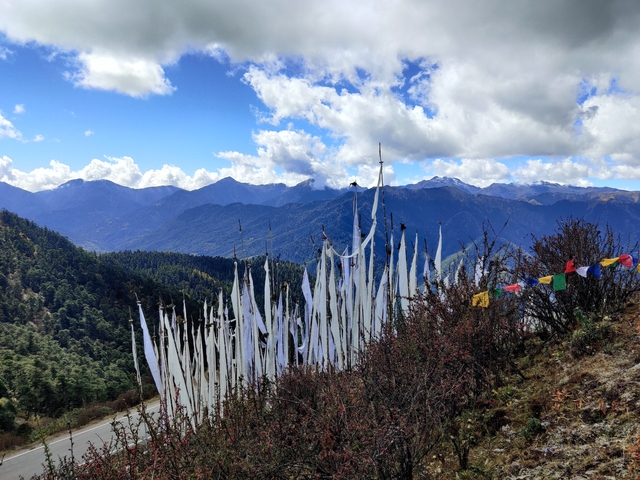 Mountains with colorful prayer flags in the foreground.