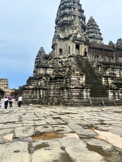 Part of Angkor Wat temple complex with tourists.
