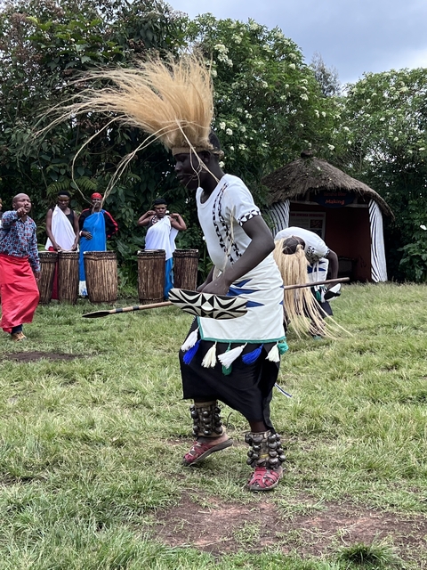 A cultural dance performance with drummers and dancers.