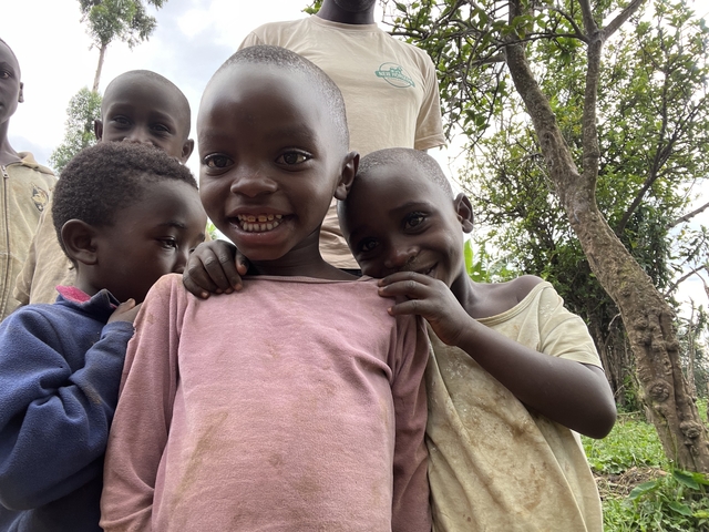 Group of smiling children outdoors.