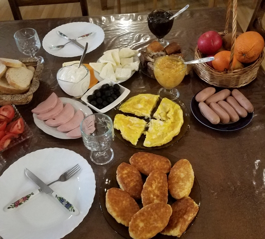 Traditional Georgian breakfast spread with various foods.