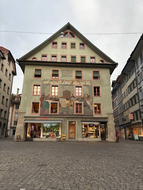 Painted building with intricate design in a European city.